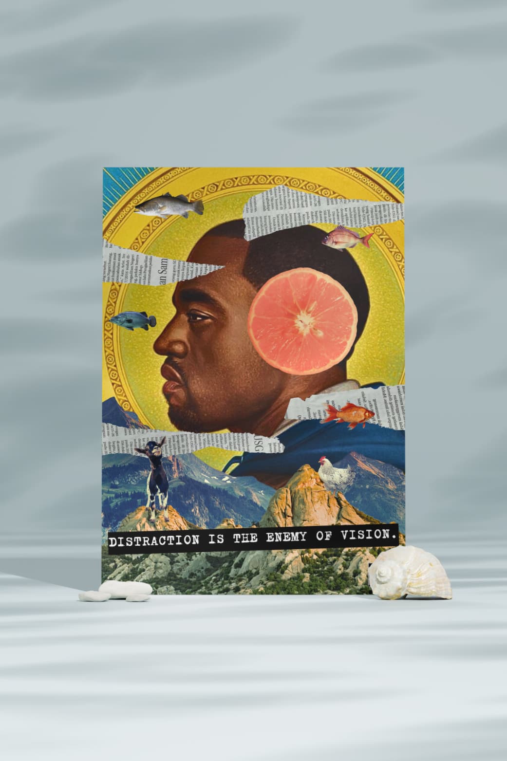 A collage featuring Kanye West's face with a grapefruit for his head, surrounded by various natural elements like fish, a goat, and a mountain. The text "DISTRACTION IS THE ENEMY OF VISION" is written below.