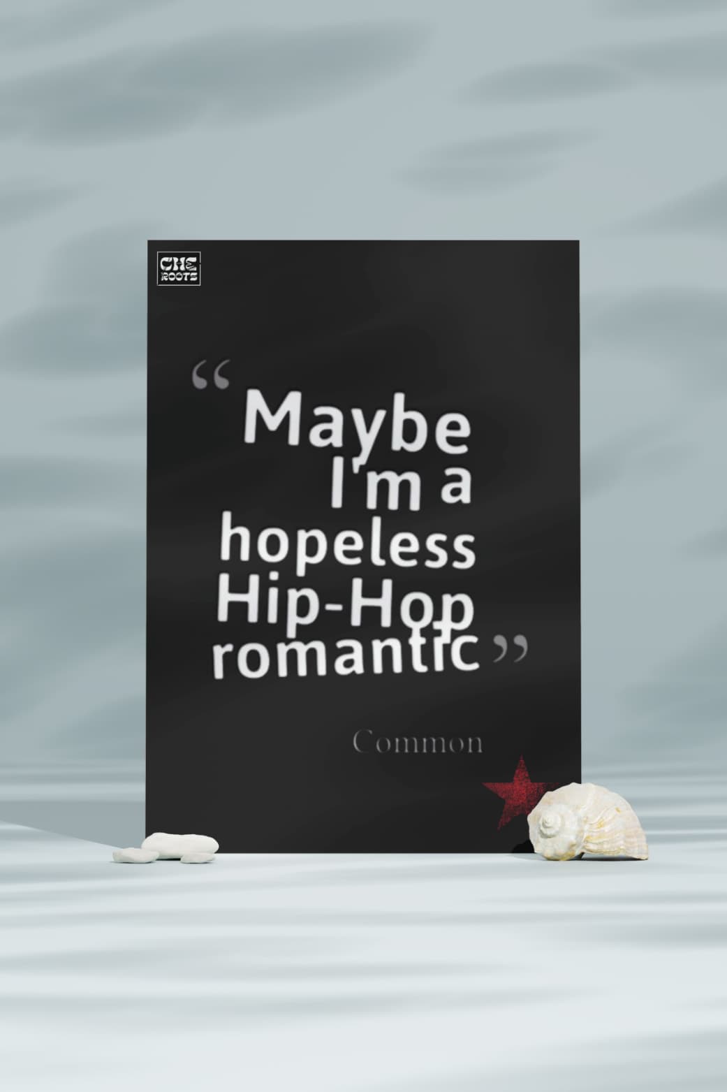 A black poster with a quote by Common: "Maybe I'm a hopeless Hip-Hop romantic." The quote is enclosed in quotation marks and attributed to Common below.